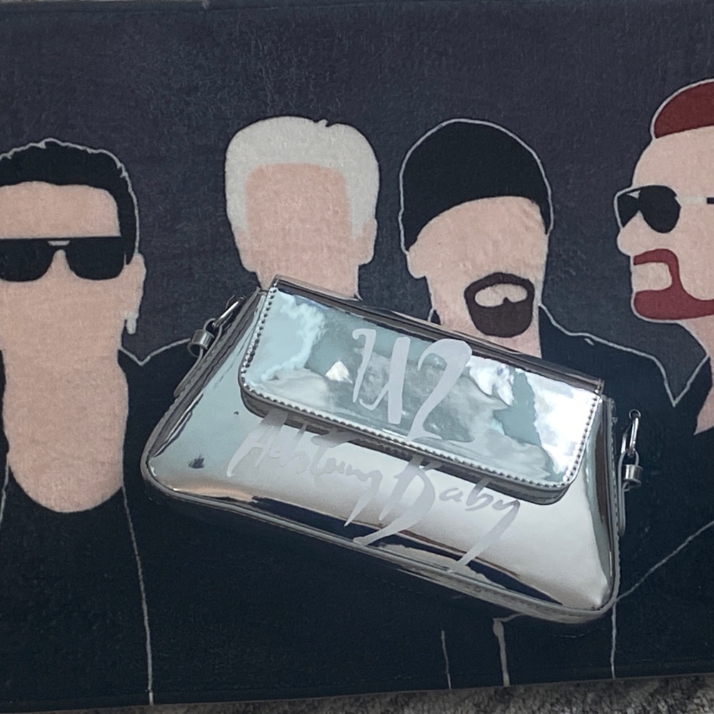Silver foil purse w/ U2 ACHTUNG BABY decal.      10”long 5”high,w/strap and bag
